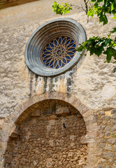 Closeup of a historic building with it's round window in Valldemossa, Majorca, Spain