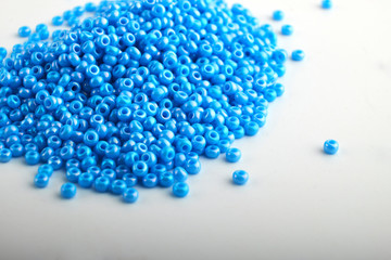 Multi-colored beads.Colorful beads on a wooden surface.It is used in finishing fashion clothes.Variety of shapes and color to make abead necklace or a string of beads toplease a woman of fashion.