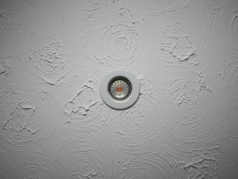 LED downlight in swirly patterned ceiling plaster pattern known as Artex was common in the 80s
