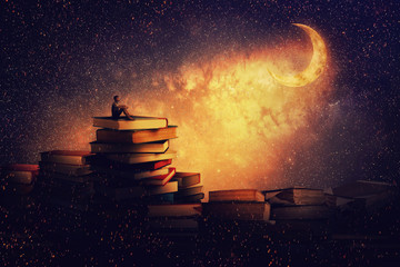 Boy sitting alone on a pile of books, looking a the new moon. Magic night tale scene. In search of knowlegde concept. - obrazy, fototapety, plakaty