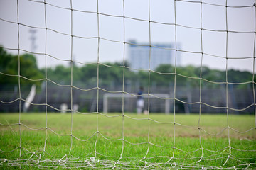 Empty soccer field in a sports complex, Picture is captured behind soccer goal.