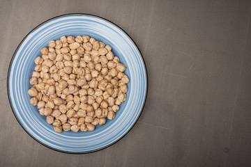 Chickpeas in the blue plate on the table
