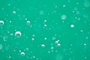 Beautiful turquoise background. Rising air bubbles in clear water. Oxygen. Macro