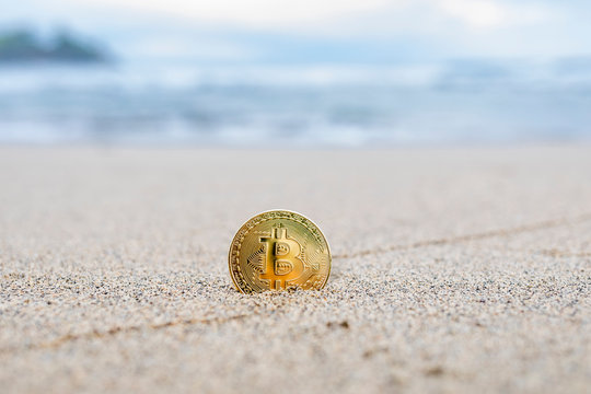 Bitcoin on a sandy beach
