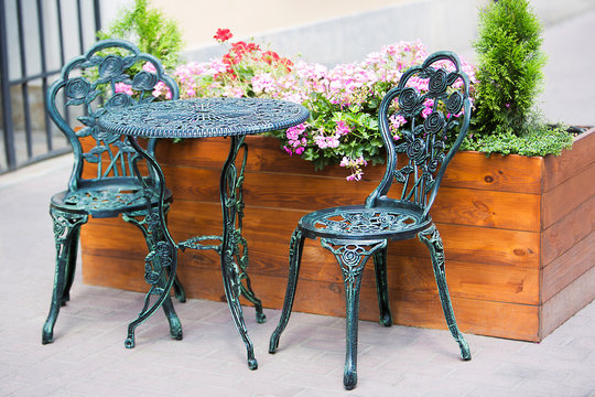 Wrought Iron Table And Chairs In The Garden