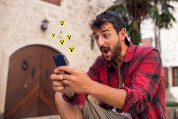 Amazed man looking in smartphone