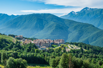 View of the hotel complex in the mountains covered with green forests