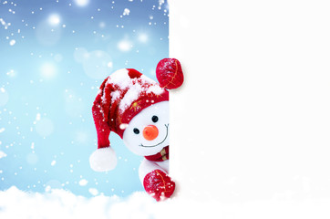 Little snowman in caps and scarfs on snow in the winter. Background with a funny snowman. Christmas...