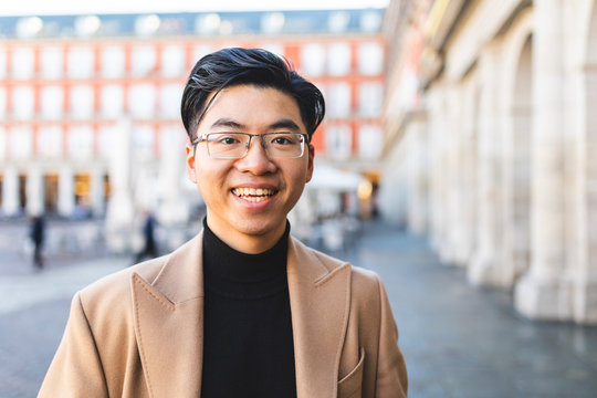 Spain, Madrid, portrait of happy young man at Plaza Mayor