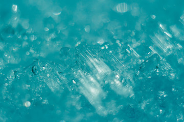 winter crystal icy abstract bokeh background. bright blue shining sparkles. Christmas and new year holiday theme background. defocused and selected focus