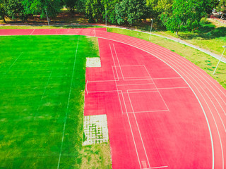 stadium with green grass and red running line