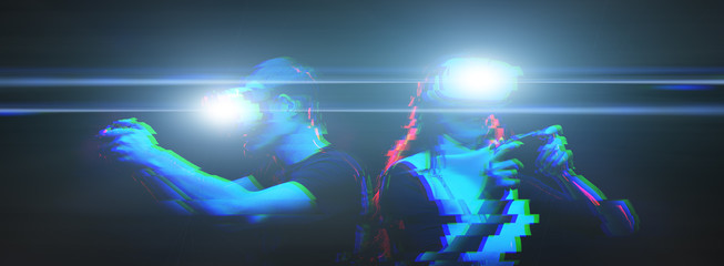 Obraz premium Couple with virtual reality headset are playing game. Image with glitch effect.