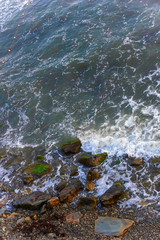 sea waves sea foam.  top view. stones beach