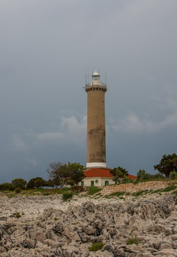 Croatia, Dugi otok, Veli rat, 9. july 2019. On the photo is famous lighthouse. Photo was taken on the very cloudy summer day. Vertical photo. No people.
