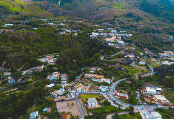 Fototapeta na wymiar buildings in the mountains at ischia island from the drone view