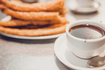 Heat the butter in a wide pan and put churros into it one at a time, closing them into rings - fry each for about three minutes, turning on each side