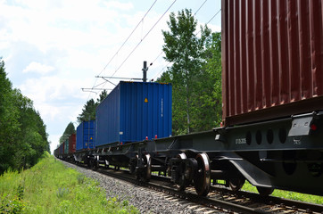 Obraz premium Freight train, transportation of railway cars by cargo containers shipping. Railway logistics concept - Image