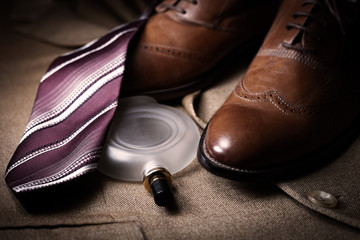 set of classic mens clothes, brown shoes, perfume and tie