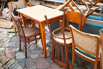 Old chairs. Discarded on the street old chairs and tables.
