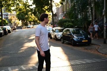Obraz premium Young caucasian man walking on the street where his house is located