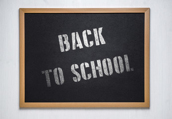 Fototapeta premium chalk board on a white wooden background. Back to school concept. Back 2 school concept