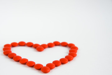 card with a heart made of red pills