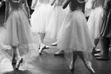 Corps de ballet actresses in the theater rehearsal hall in costumes and pointe