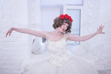 Adult fashion model wearing red roses on head and white wedding bride dress on white background.