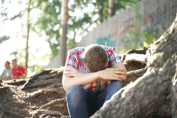 Portrait of a tired student of school. the boy wants to sleep in nature.