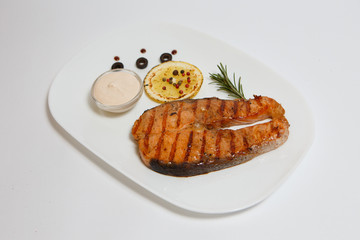 grilled red fish steak on a white plate