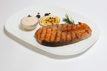 grilled red fish steak on a white plate