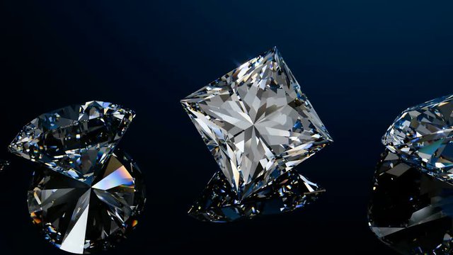 Ten variously cut diamonds move in line on black glossy background. Seamless loop animation