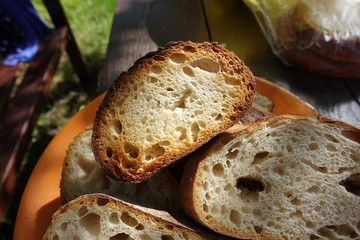 Toasted bread on the fire, cooked on skewers, illuminated by the sun.