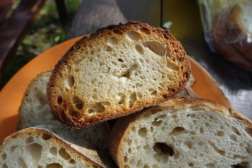 Toasted bread on the fire, cooked on skewers, illuminated by the sun.