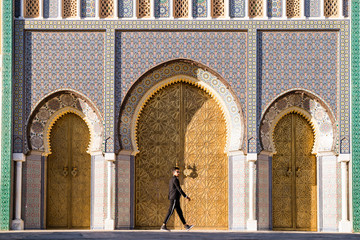 Moroccan man with sunglasses and suit next to Royal Palace in Fe