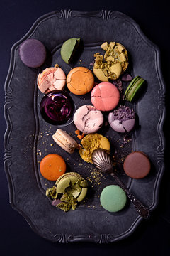 Macarons on a stylish vintage black plate viewed from above
