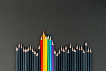 black and lgbt color pencils on black paper background. Mock up, copy space. Concept of integration...
