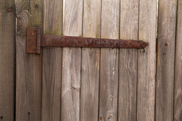 Texture.  Old and shabby wooden background. Vintage warehouse door and metal element.