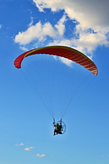 Man flying paraglider for concept design. Travel concept. Freedom, recreation, extreme sport. Summer.