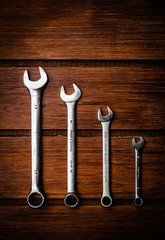 Group of wrenches on wood background