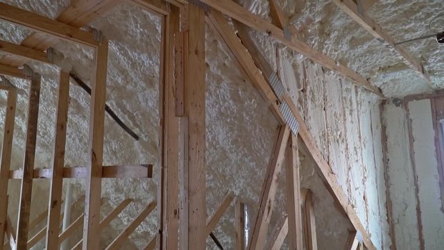 New home construction with installation of attic with foam insulation the roof