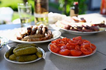 Sliced tomato on a plate and cucumber.