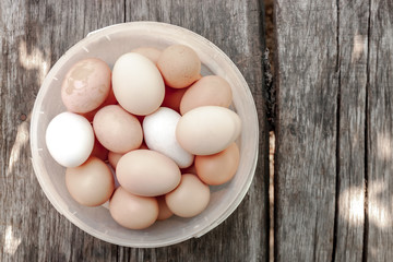 close up bucket with collection of hen eggs. flat lay at wooden background. agricultural hen eggs concept.