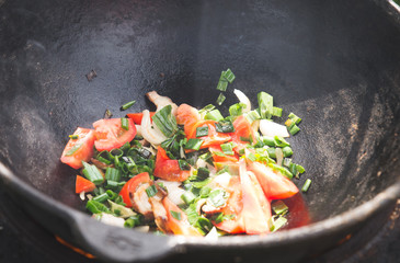 Yellow and orange carrot in cauldron. Pilaf cooking process.