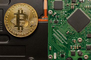 Physical bitcoin on top of a circuit board.