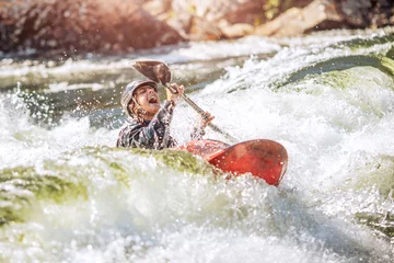 Fototapeten Guy in kayak sails mountain river. Whitewater kayaking, extreme sport rafting © Parilov