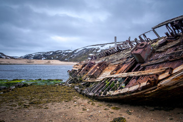 Old rusty rotten boat on Teriberka. Russian north