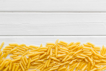Italian pasta on white wooden table background top view mock up