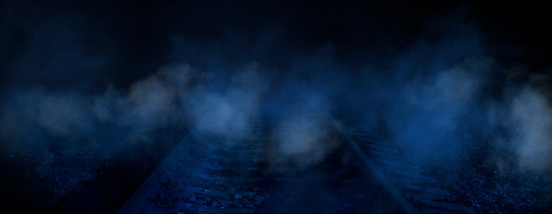 Dark night street scene with railway, night light, smoke.