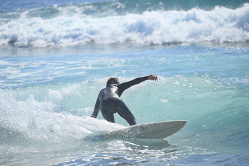 surfing in the ocean with a strong wave